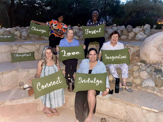 Photo of people holding pillows with words on them